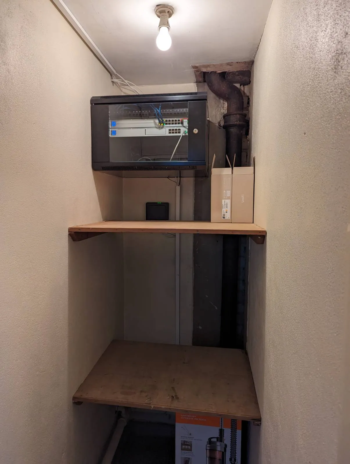 Wall-mounted network cabinet with switch and UniFi equipment installed